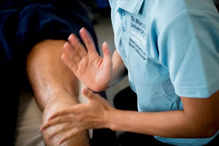 A person getting a sports massage from a massage therapist at St Mary's School of Massage in London.