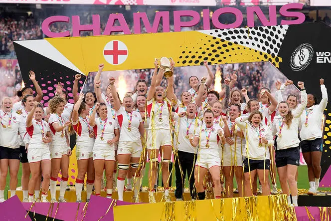 England women's rugby team lifting world cup trophy in twickenham stadium