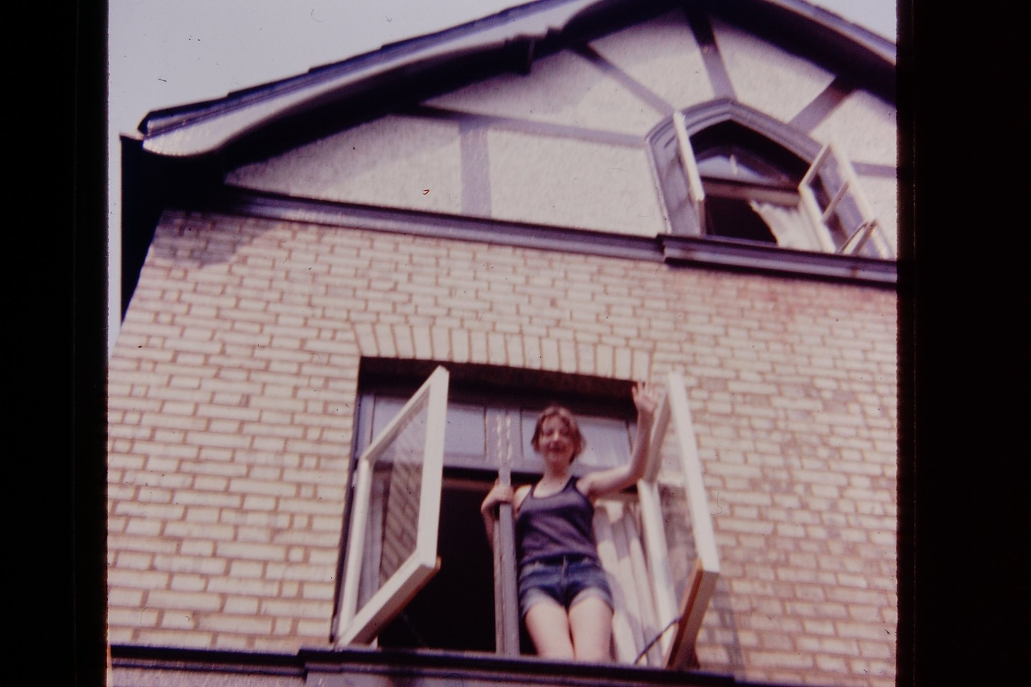 Student waving from window