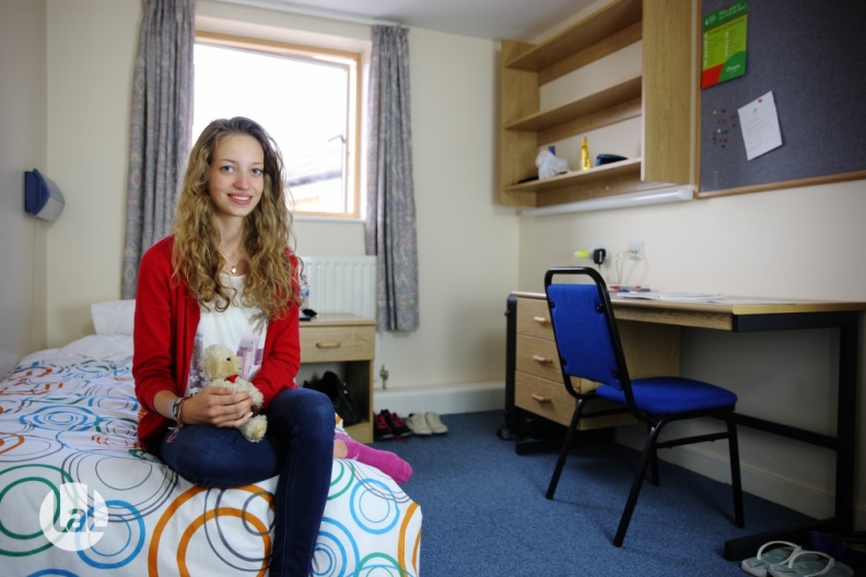 Student sat on their bed in halls of residence