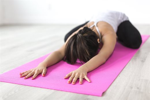 Women lying on mat doing yoga