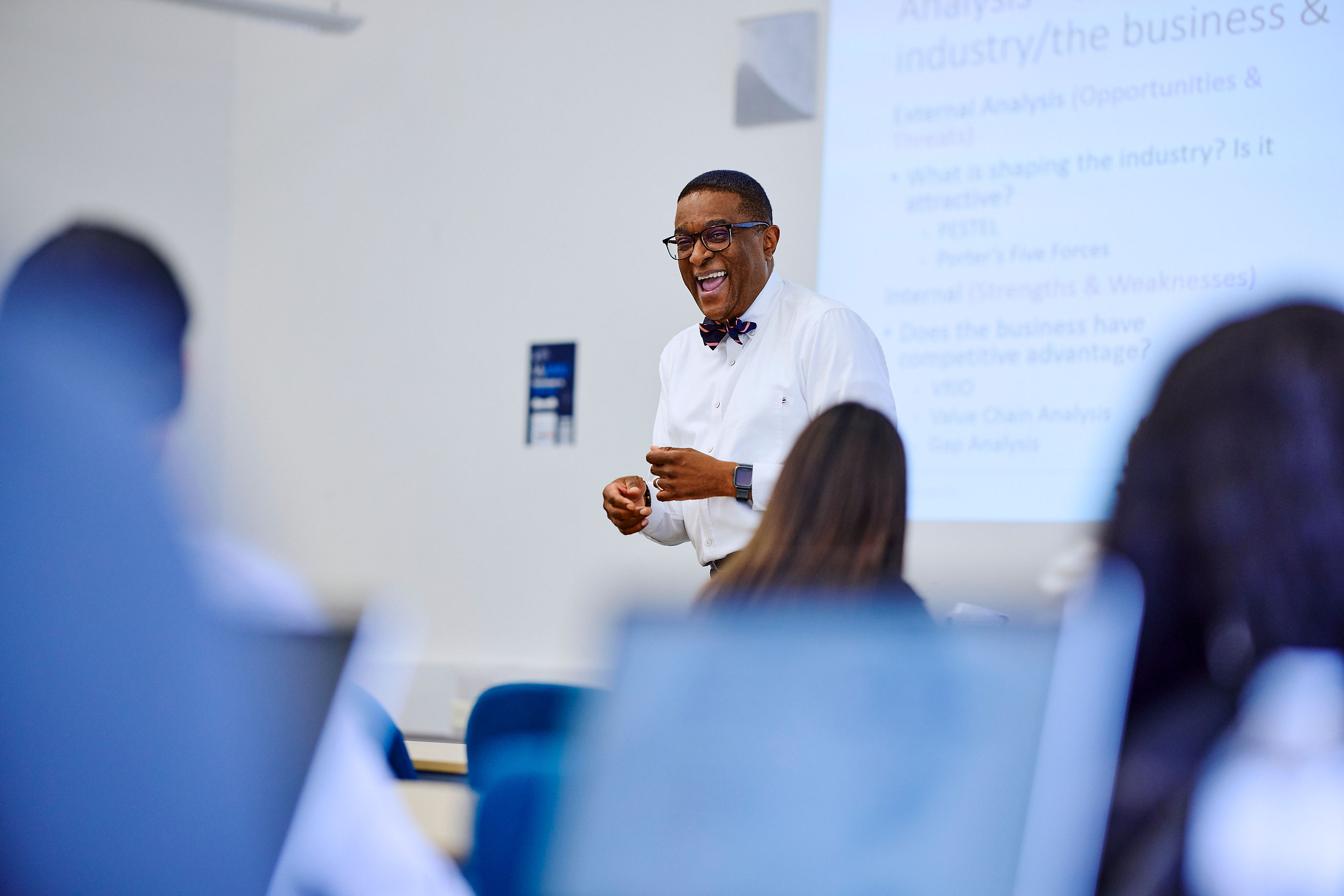 Kofi business lecturer teaching and laughing