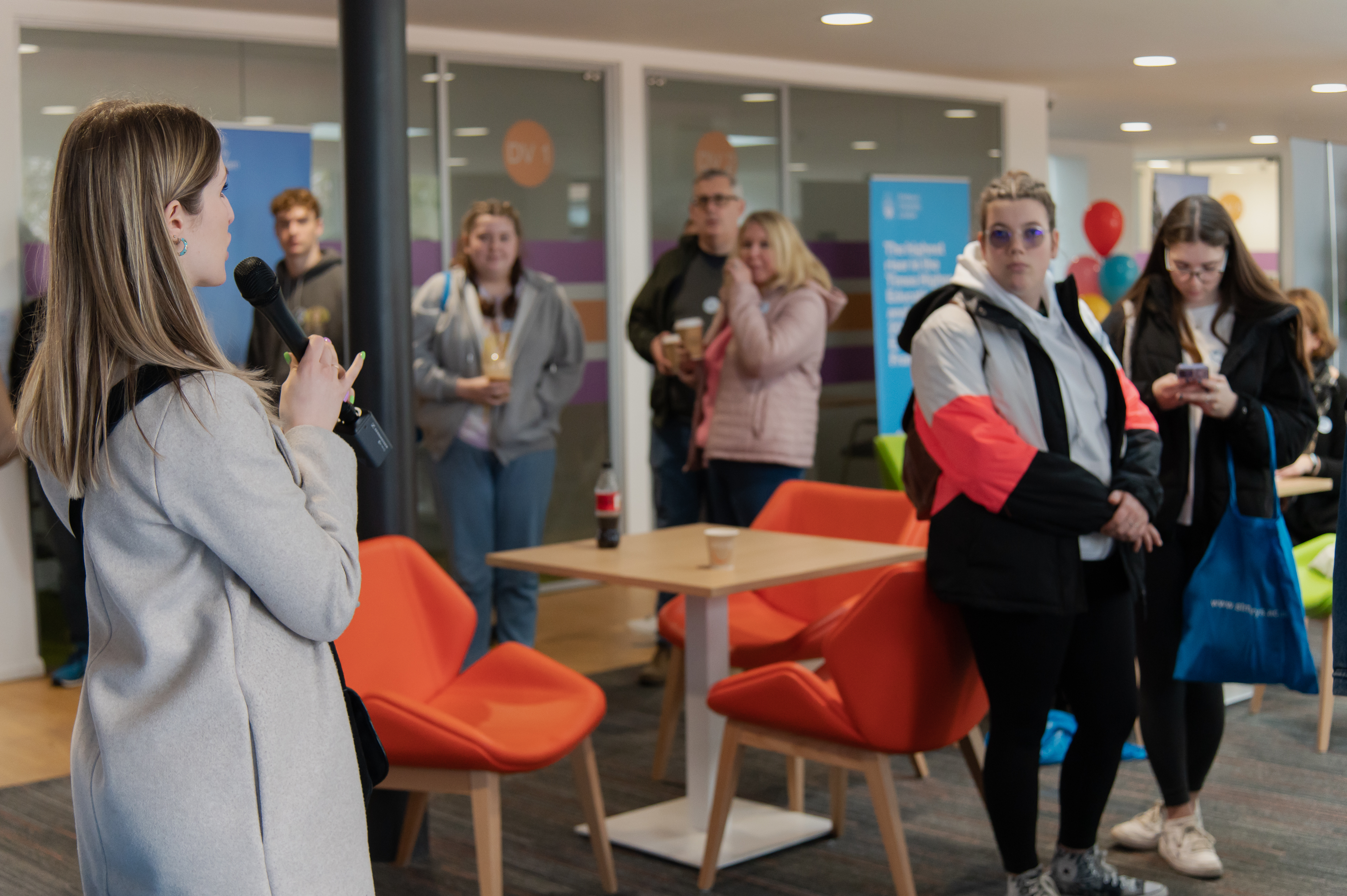 A university staff member organizing campus tours at an Open Day.