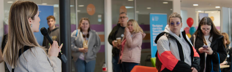 A university staff member organising Campus Tours at an Open Day.