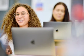 Business students work with computers as part of their business management course at St Mary's University, London.