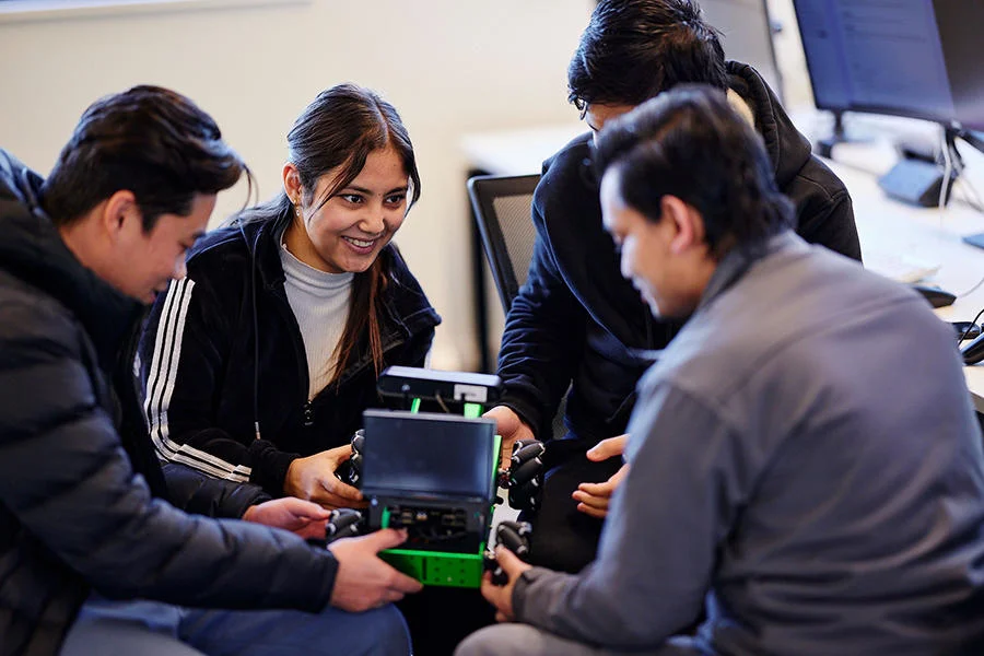 Computer science students work together in a computer science class at St Mary's University in London.