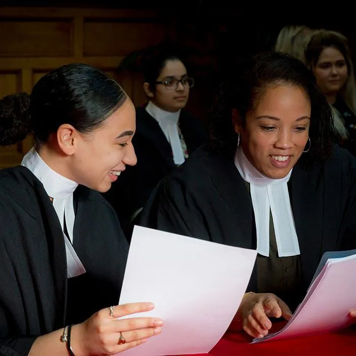 Law students sat in a moot court looking through documents.