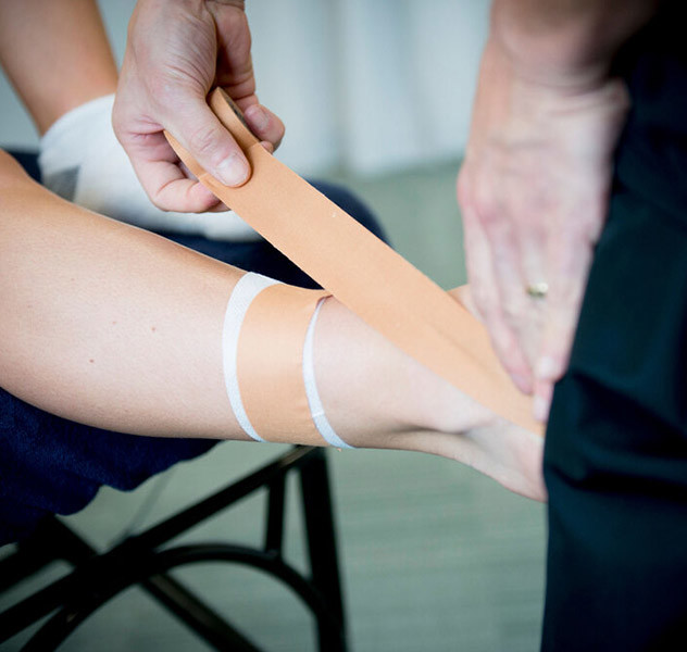 A person applying a bandage