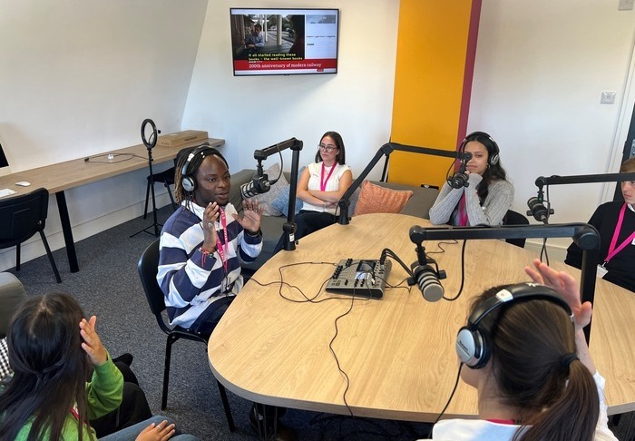 Multimedia Journalism students sat in a podcasting studio