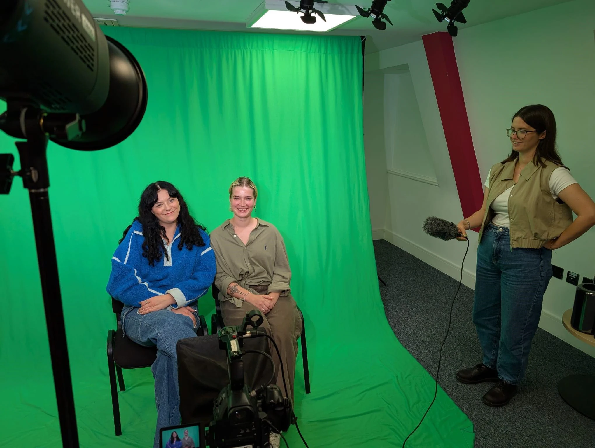 Multimedia Journalism students sat infront of a green screen.