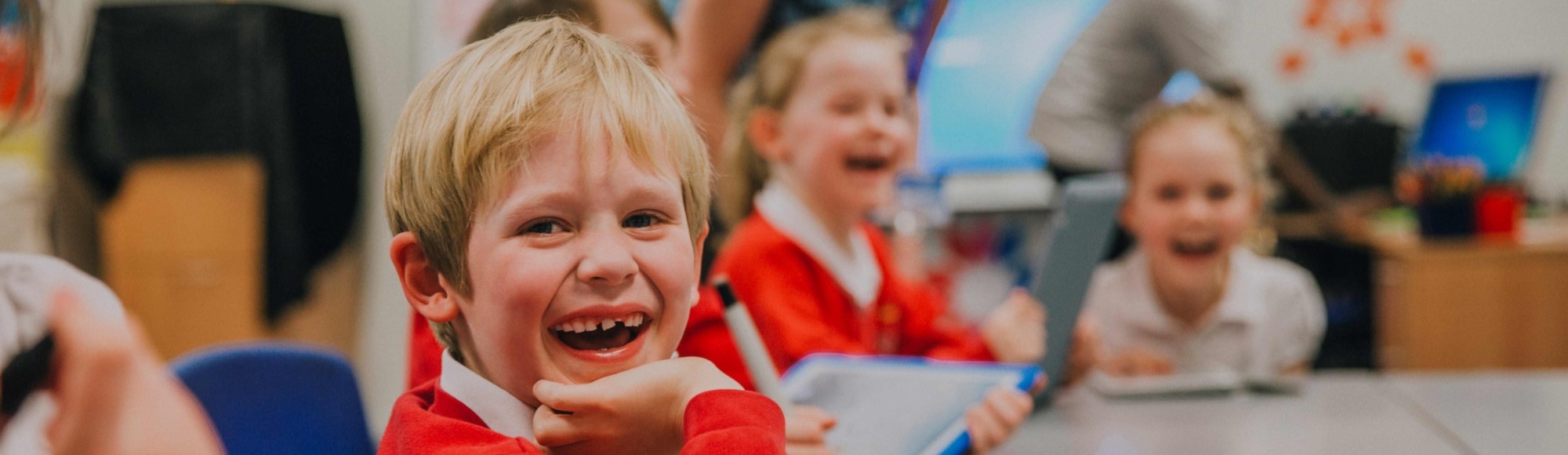 Primary school children laughing in classroom