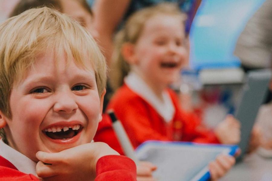Primary school children laughing in classroom