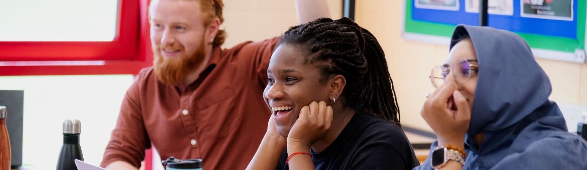students studying and laughing in classroom banner