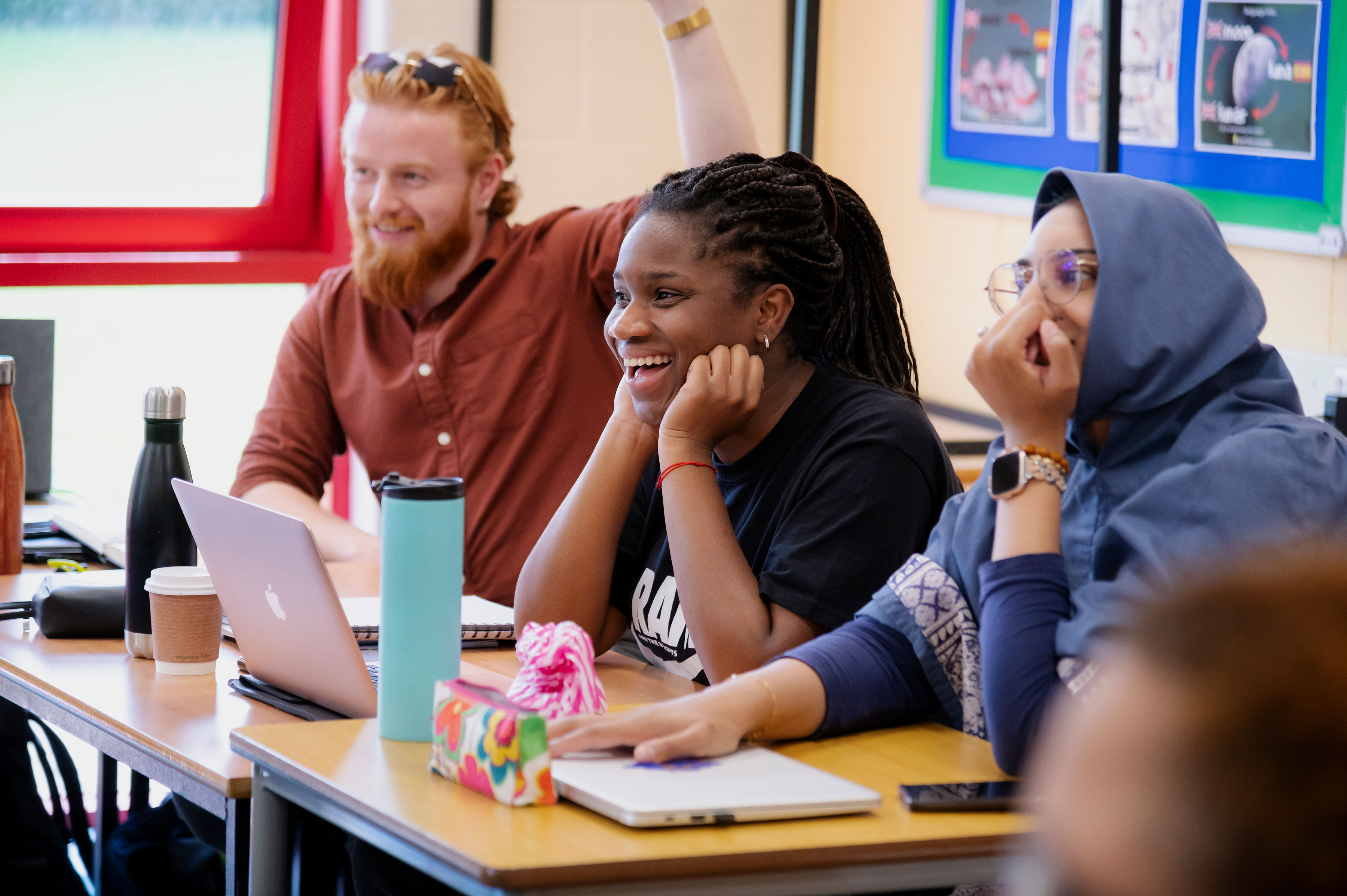students studying and laughing in classroom