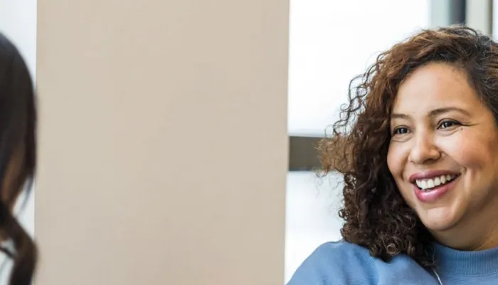 A patient and therapist talking during a health coaching session.