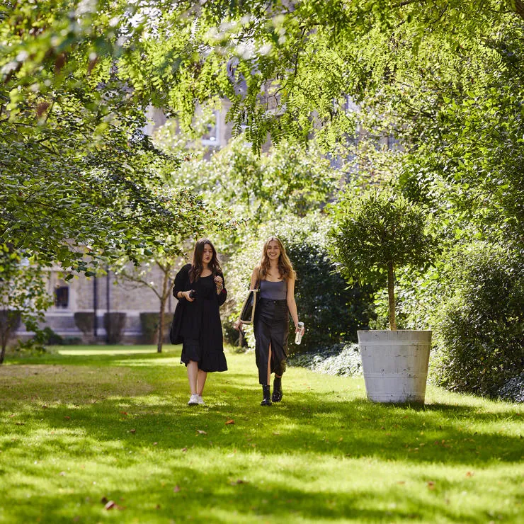 2 students walking in St Mary's green campus grounds