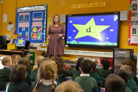 Teacher in teaching class of children