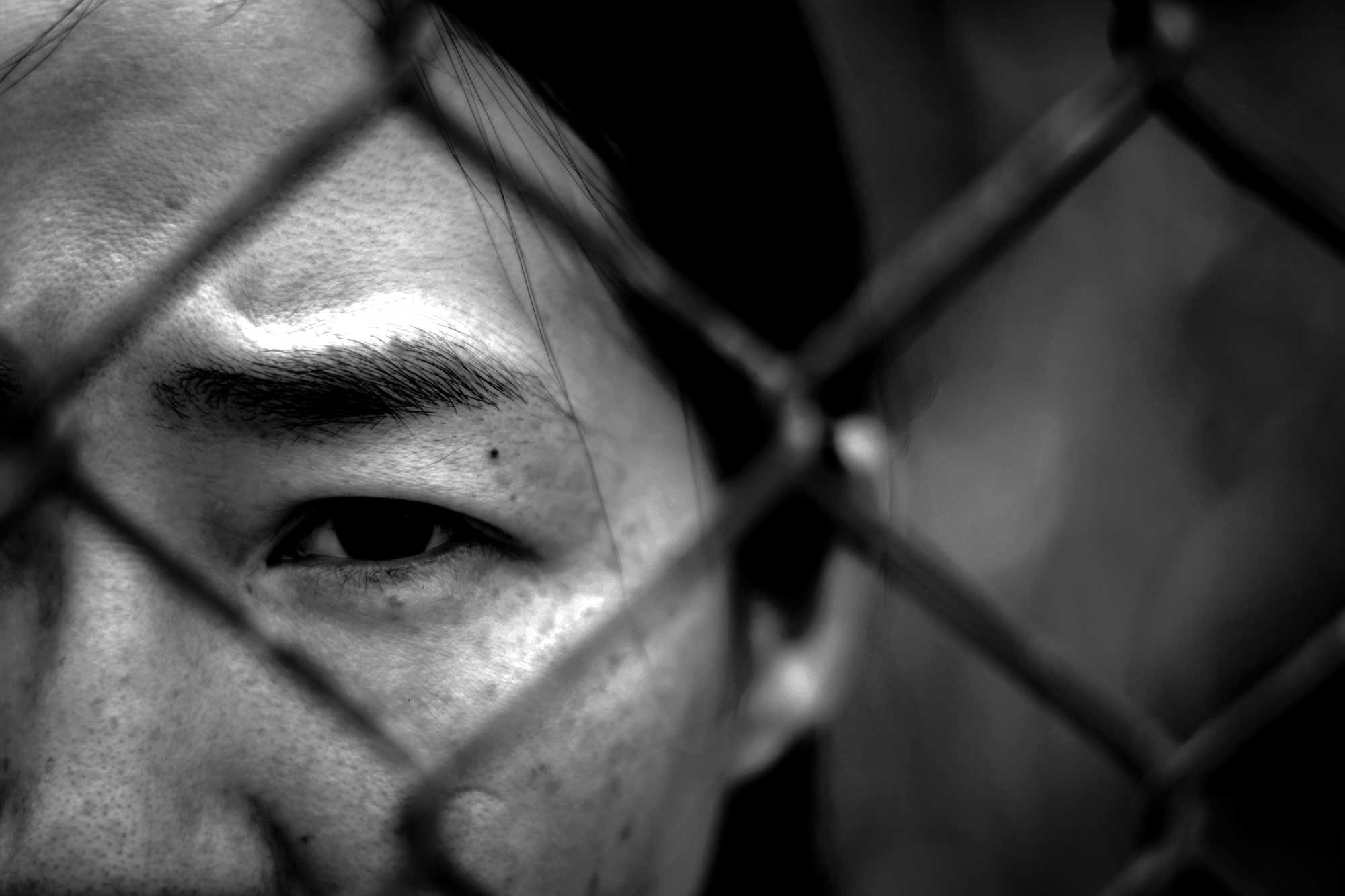 black-white-woman-behind-fence