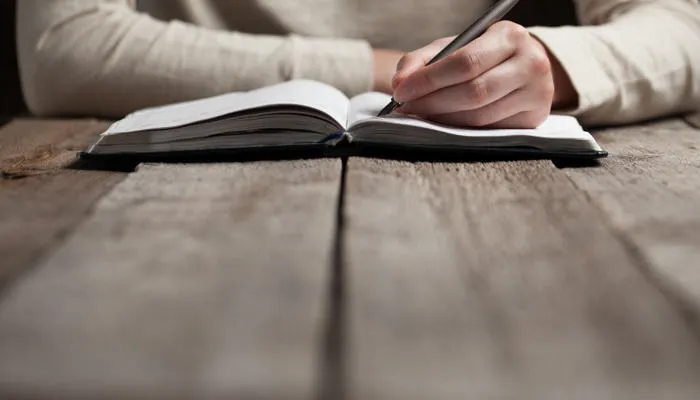 Person writing in a notebook