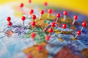 Red pins on a globe