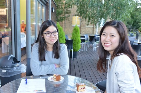 Two students eating cake at the on-campus cafe