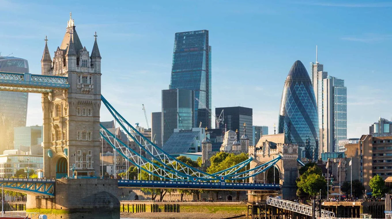 A skyline view of London's financial district, showing Tower Bridge and various other landmarks.