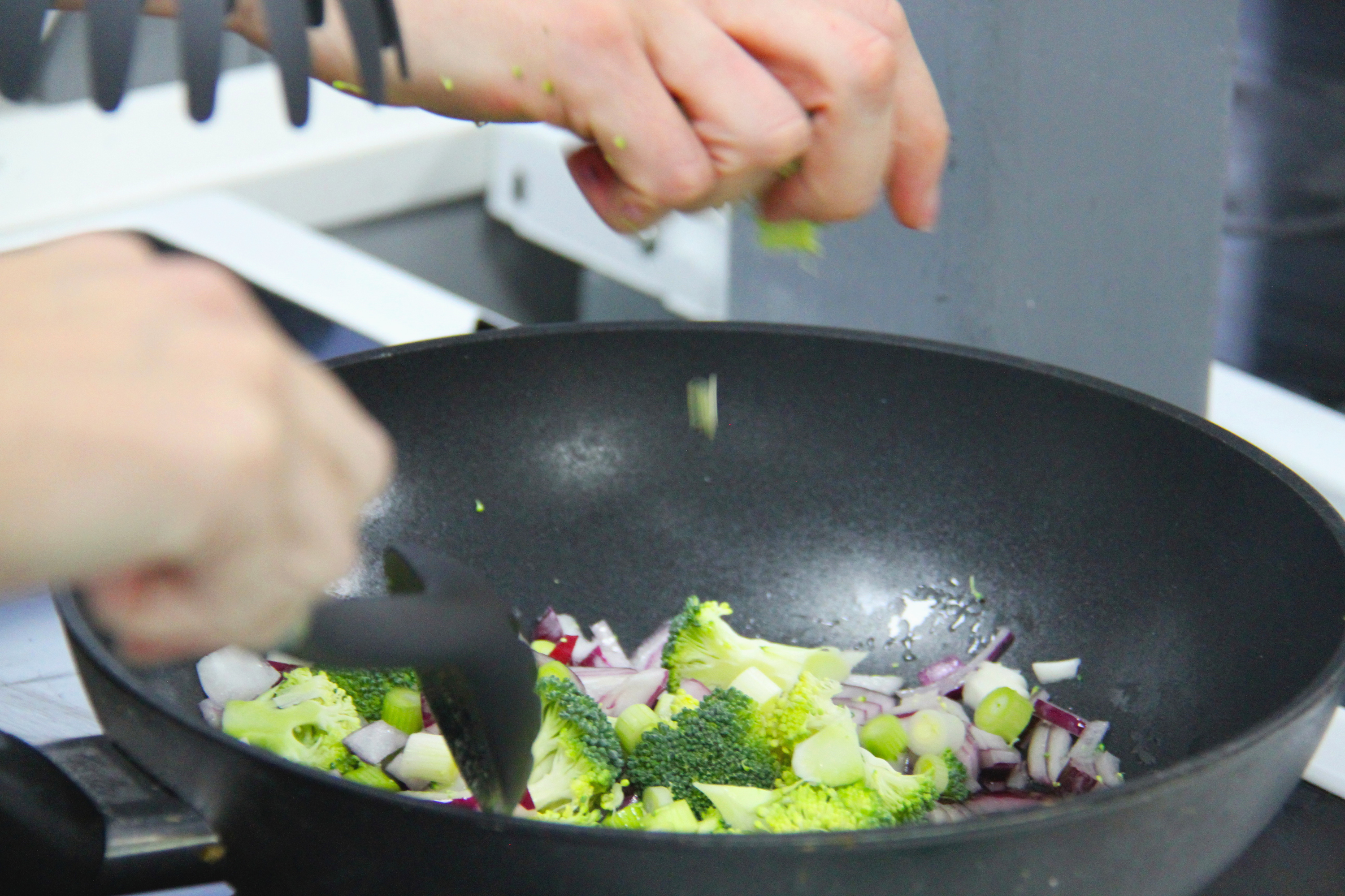 Person cooking in a wok