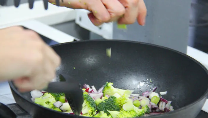 Person cooking in a wok