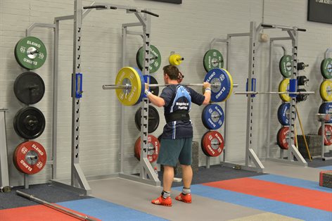 Student lifting weights in the Performance Education Centre