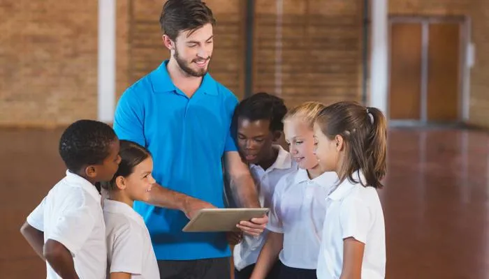 Physical Education teacher talking to students