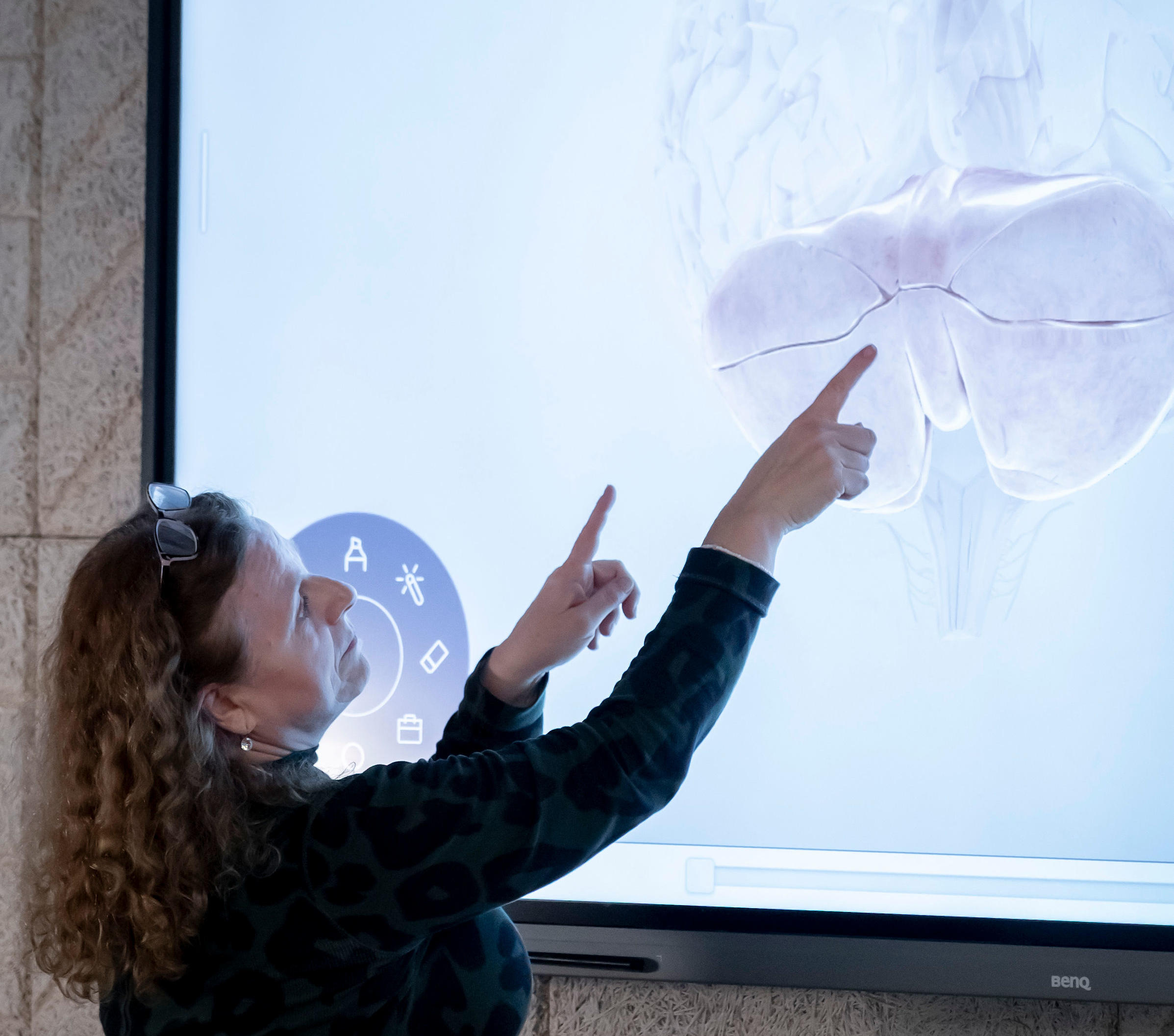 female psychology lecturer pointing to screen