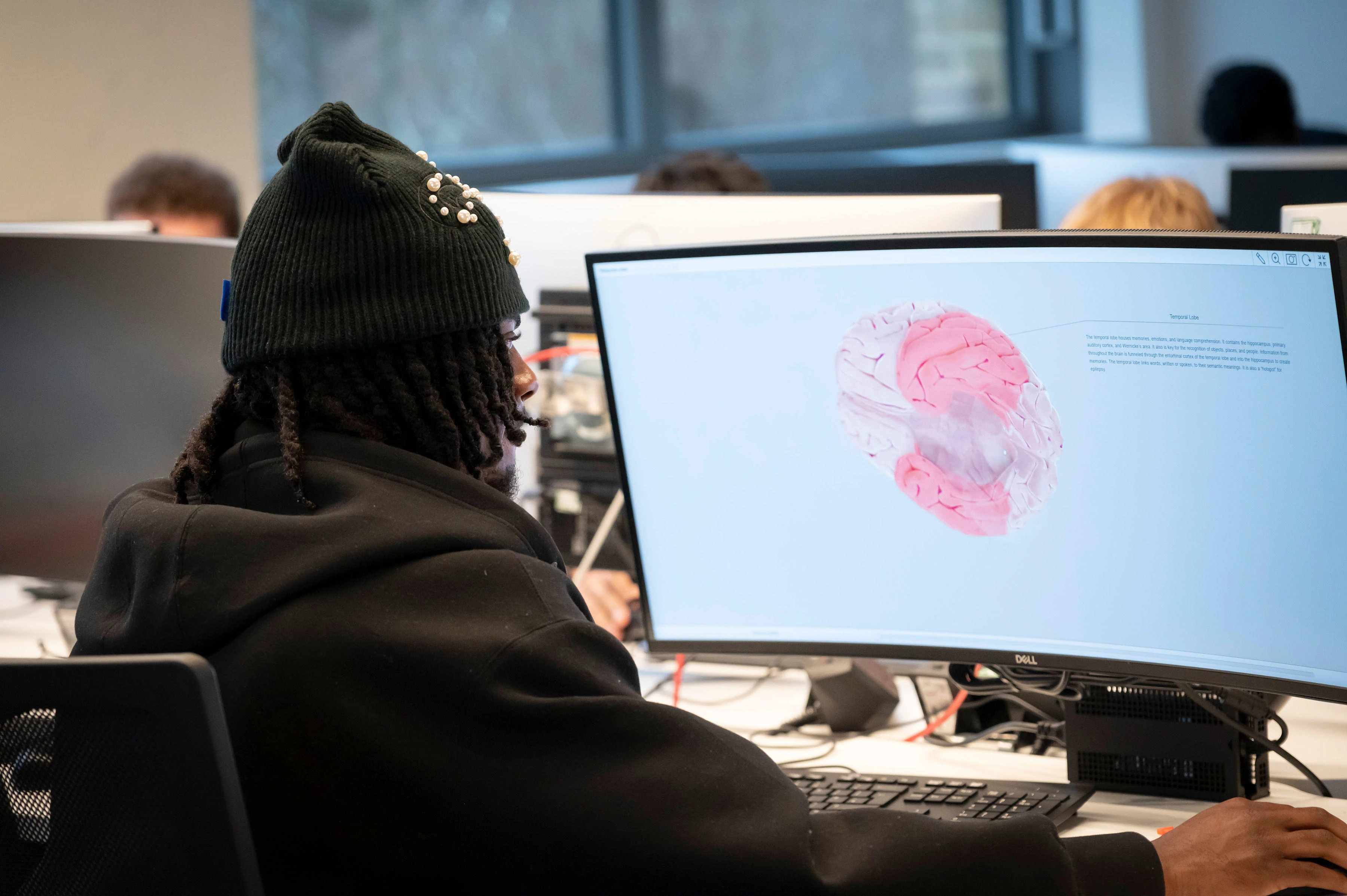 male psychology student looking at computer screen