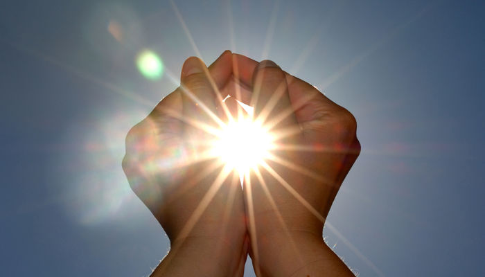 Hands holding the sun