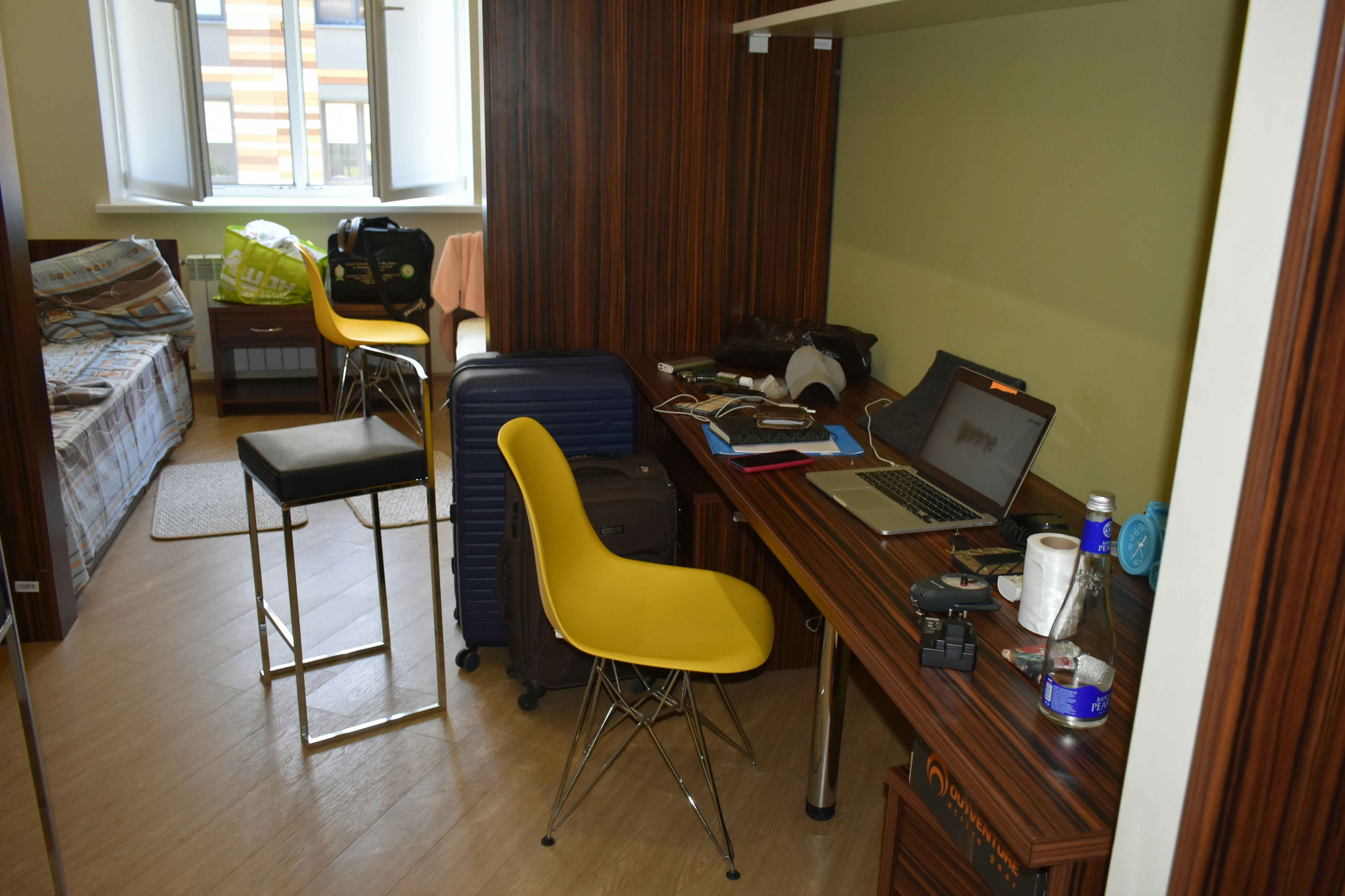 Student bedroom with a desk, laptop and revision materials set up for studying at home