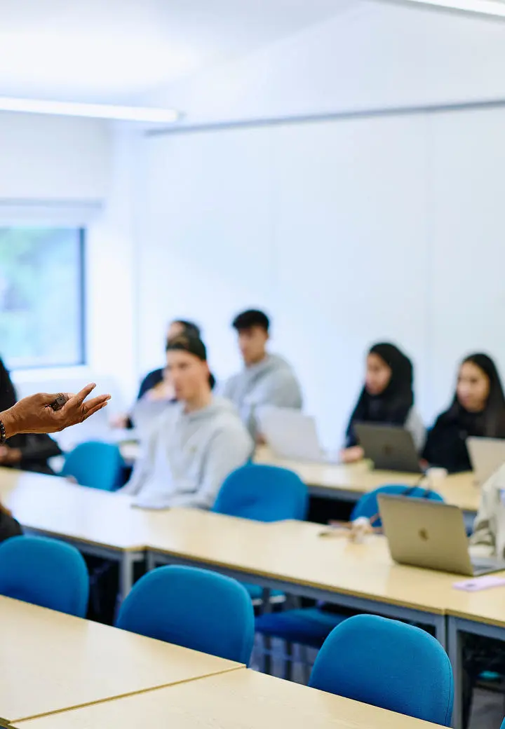Kofi business lecturer teaching to group of students