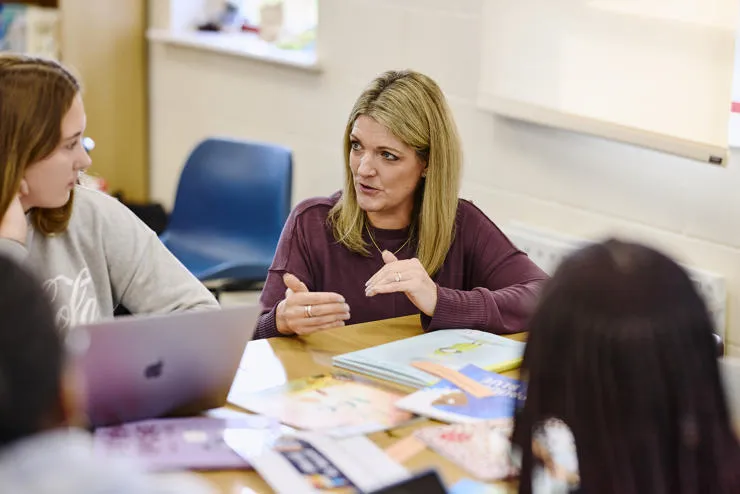 Mature students at St Mary's have a discussion with a tutor in class.