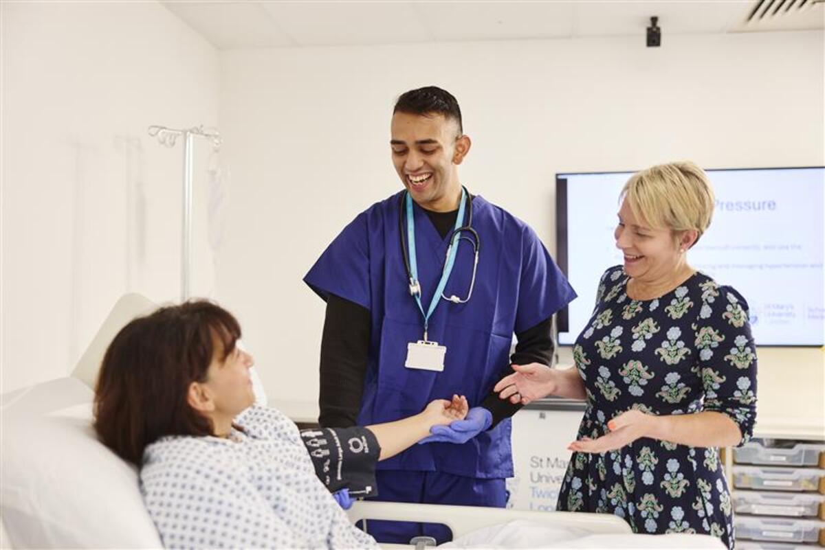A MBBS Medicine student looking after a patient under the guidance of lecturer.
