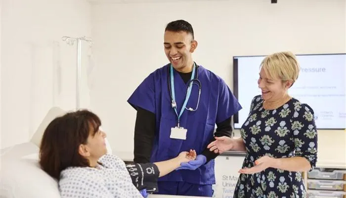 A MBBS Medicine student looking after a patient under the guidance of lecturer.