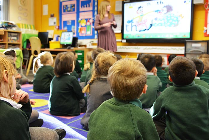 Teacher teaching school children