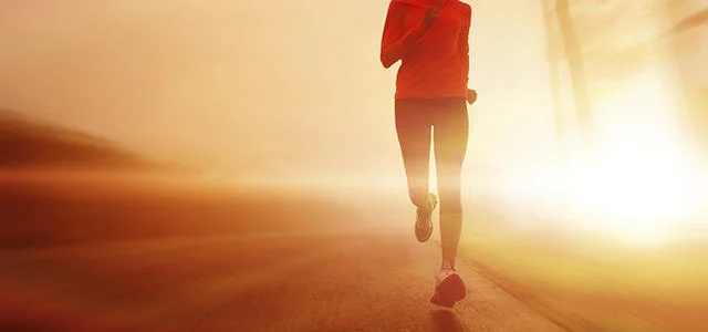 Man running at sunset.