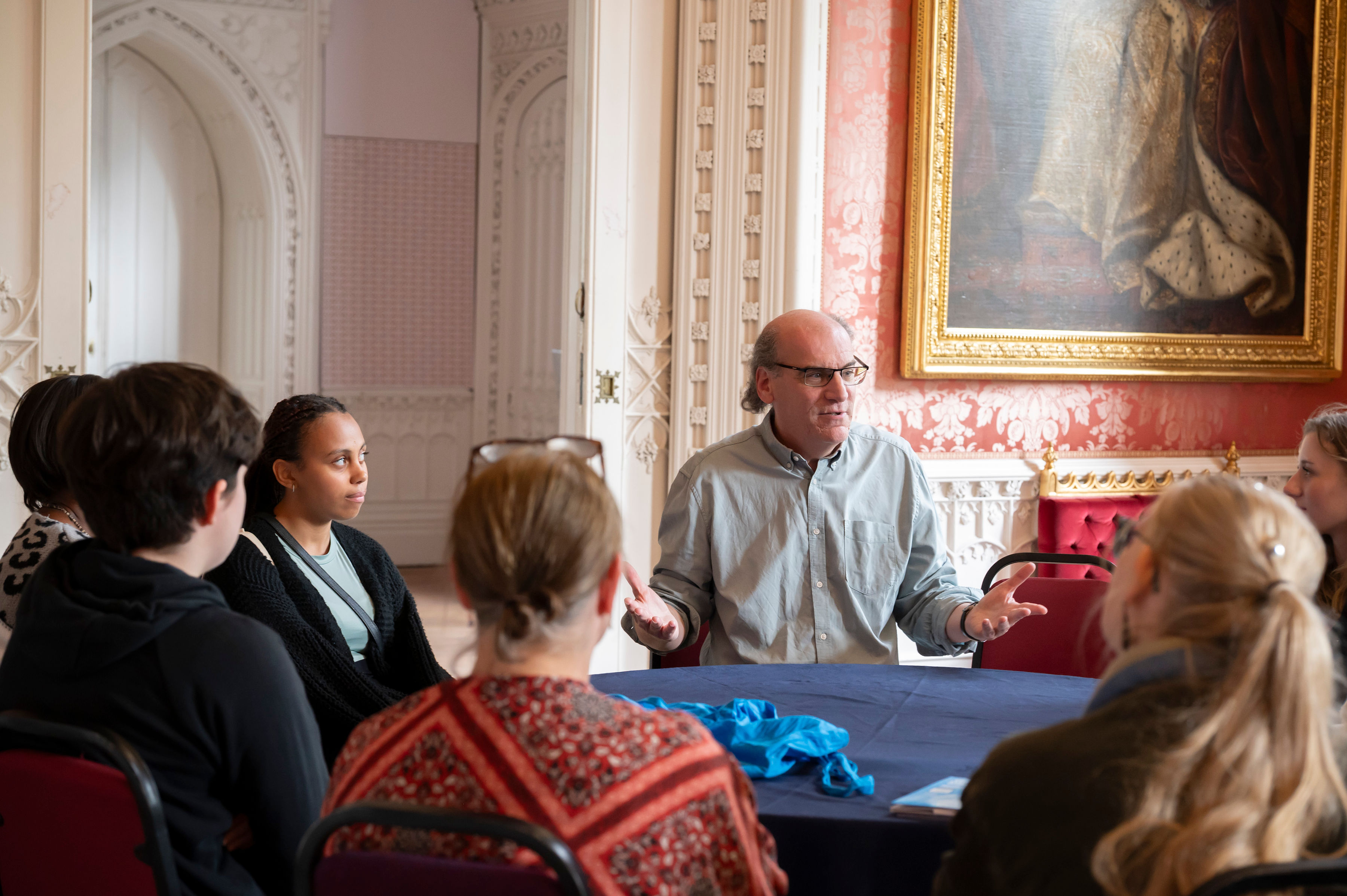 An academic talks with a group of prospective students during an open day at St Mary's University London.