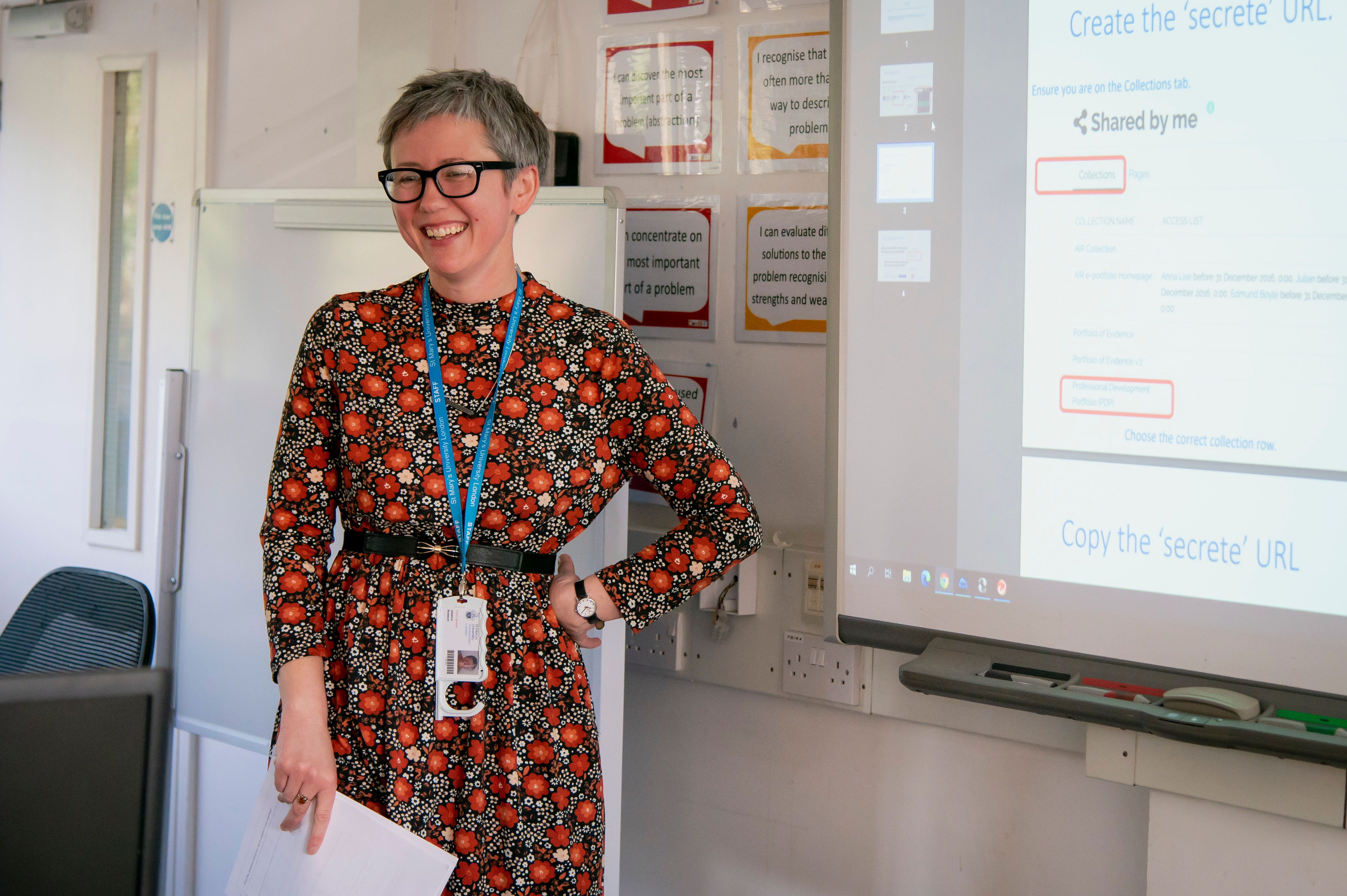 A teacher stood in front of a whiteboard screen.