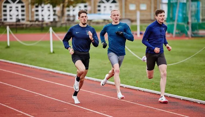 Athletes running on athletics track