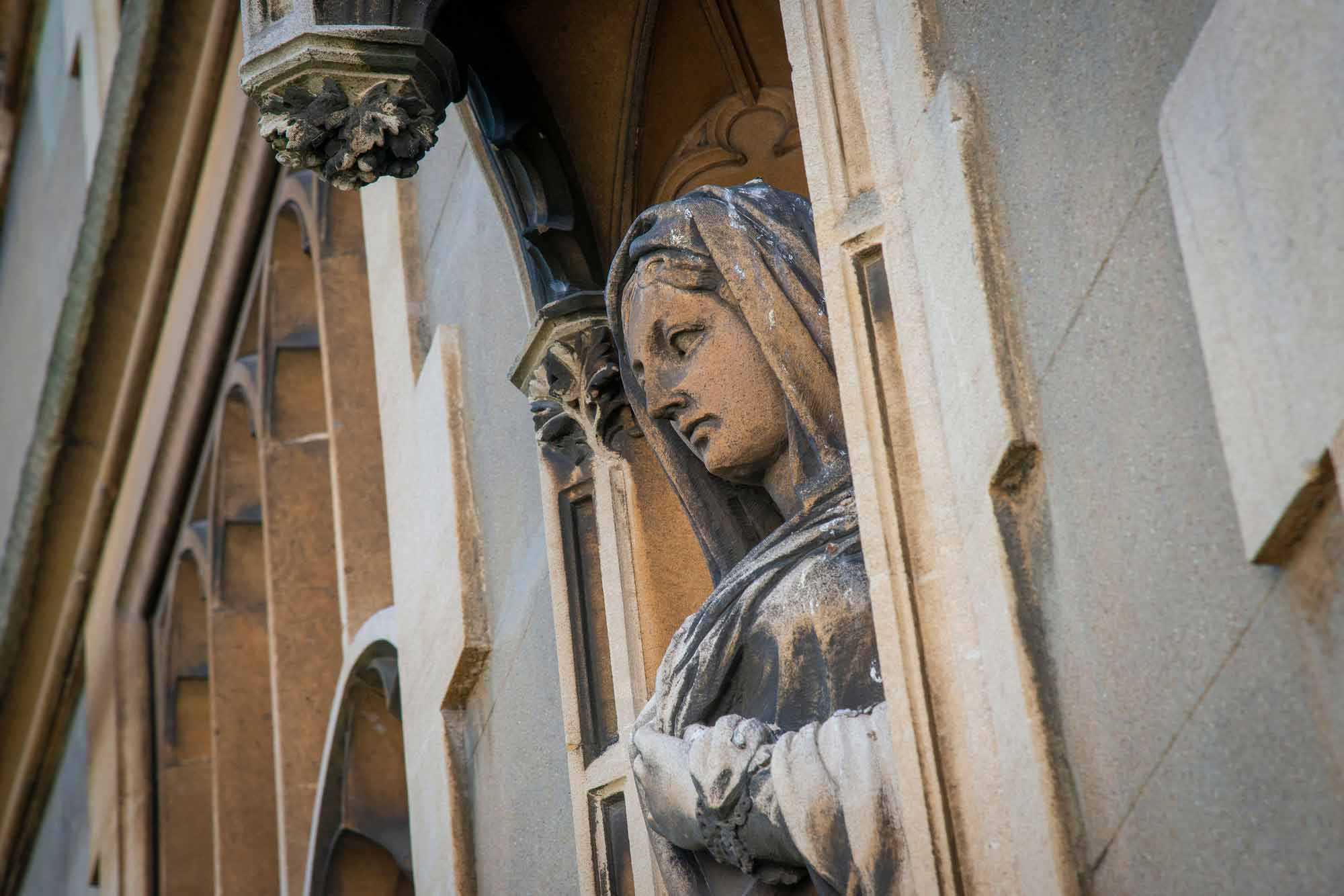 A statue on the side of a chapel.