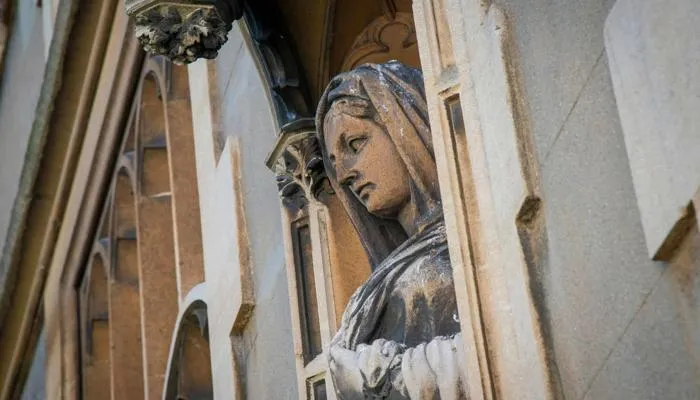 A statue on the side of a chapel.