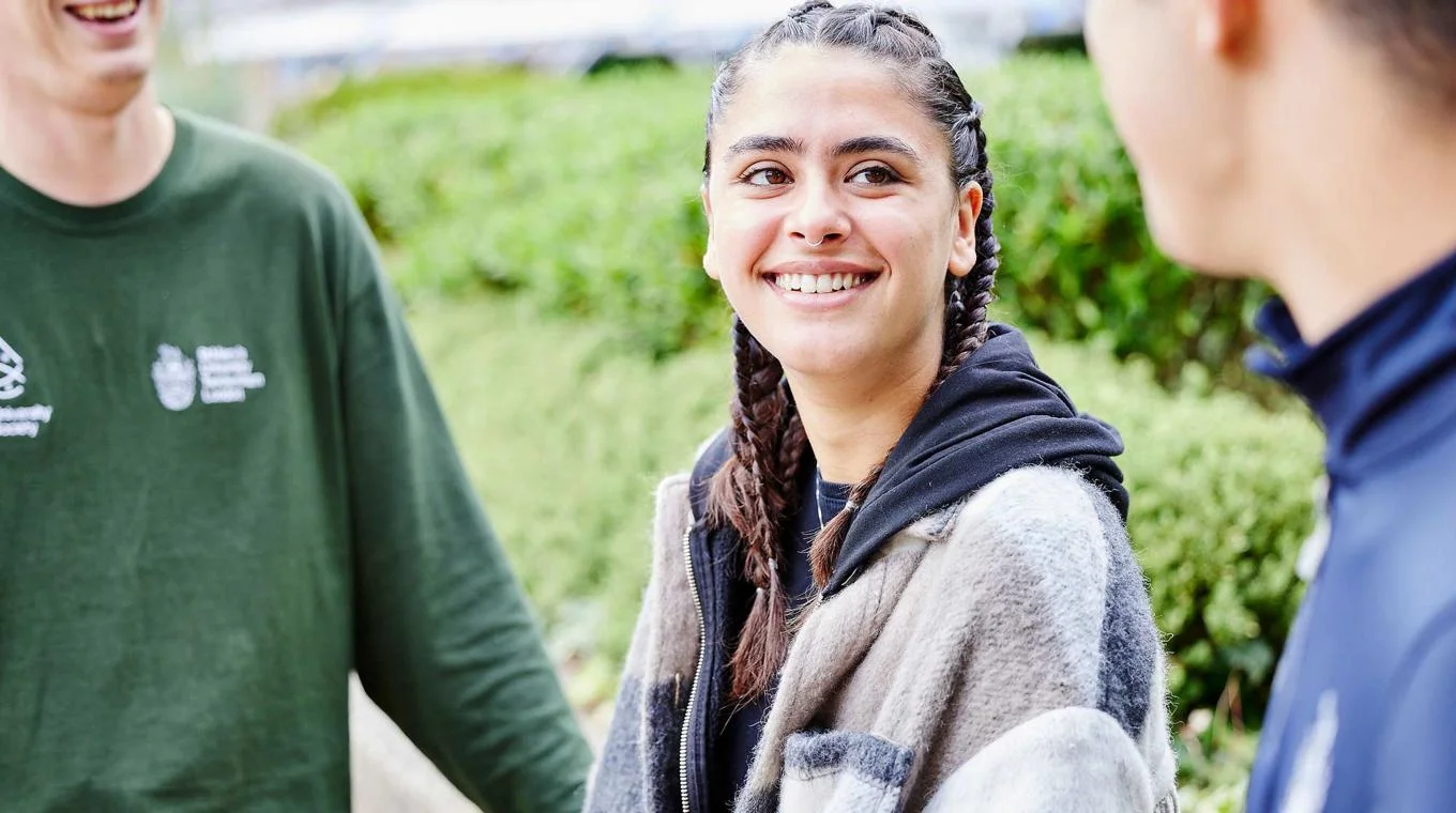 Student talking to friends outside St Mary's University London.