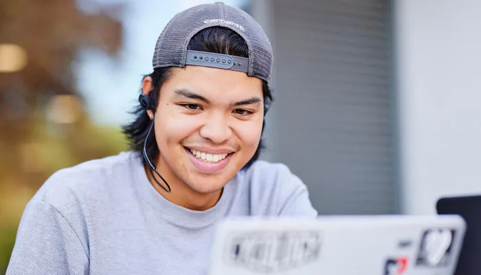 Student smiling laptop