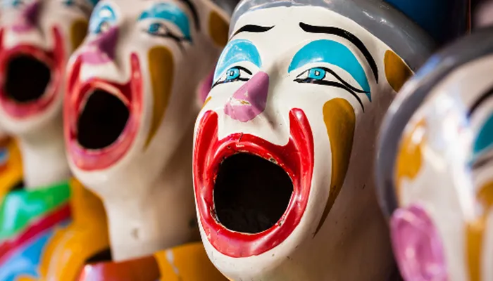 A row of colourful clown masks.