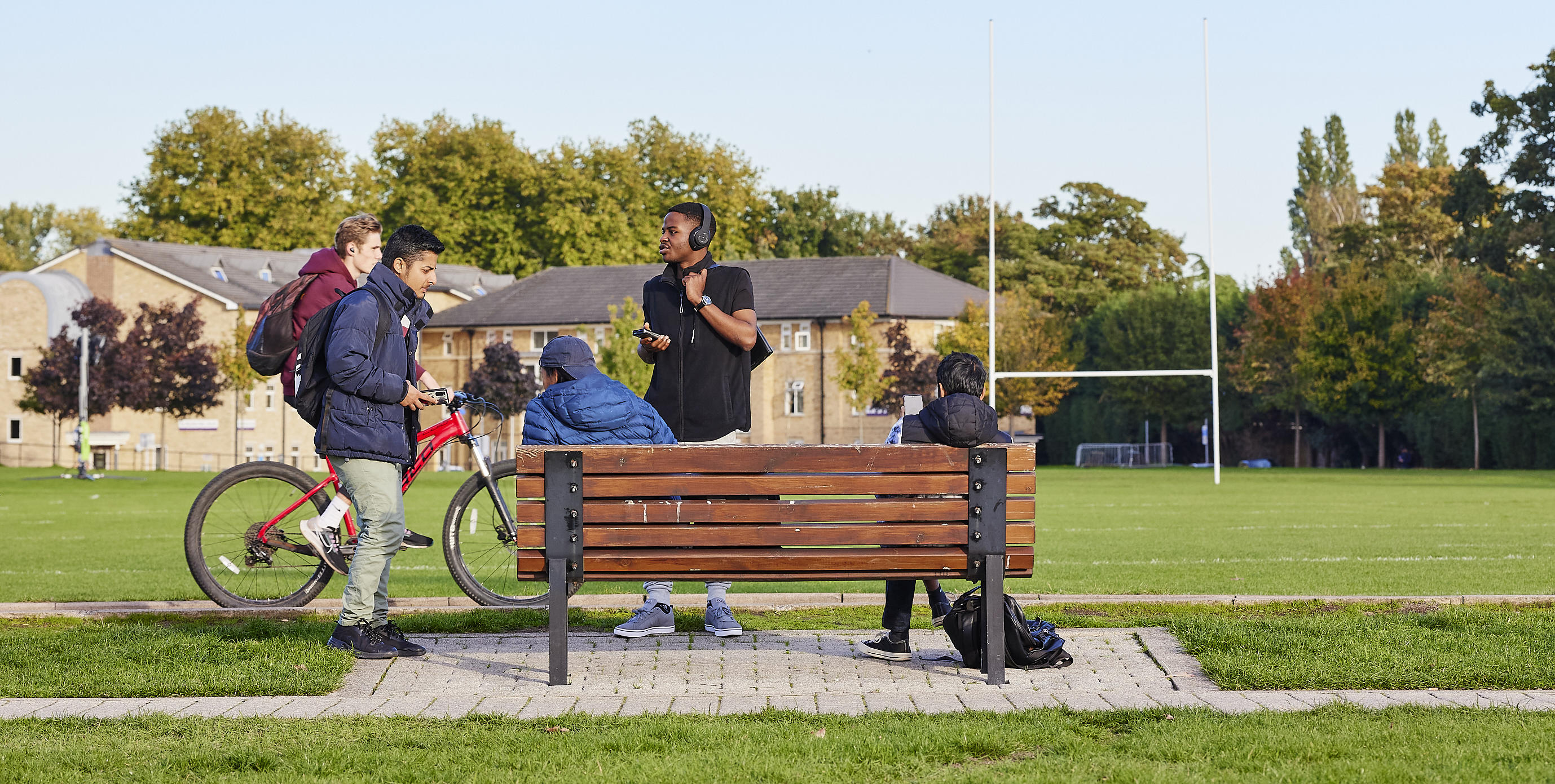 students chilling on bench