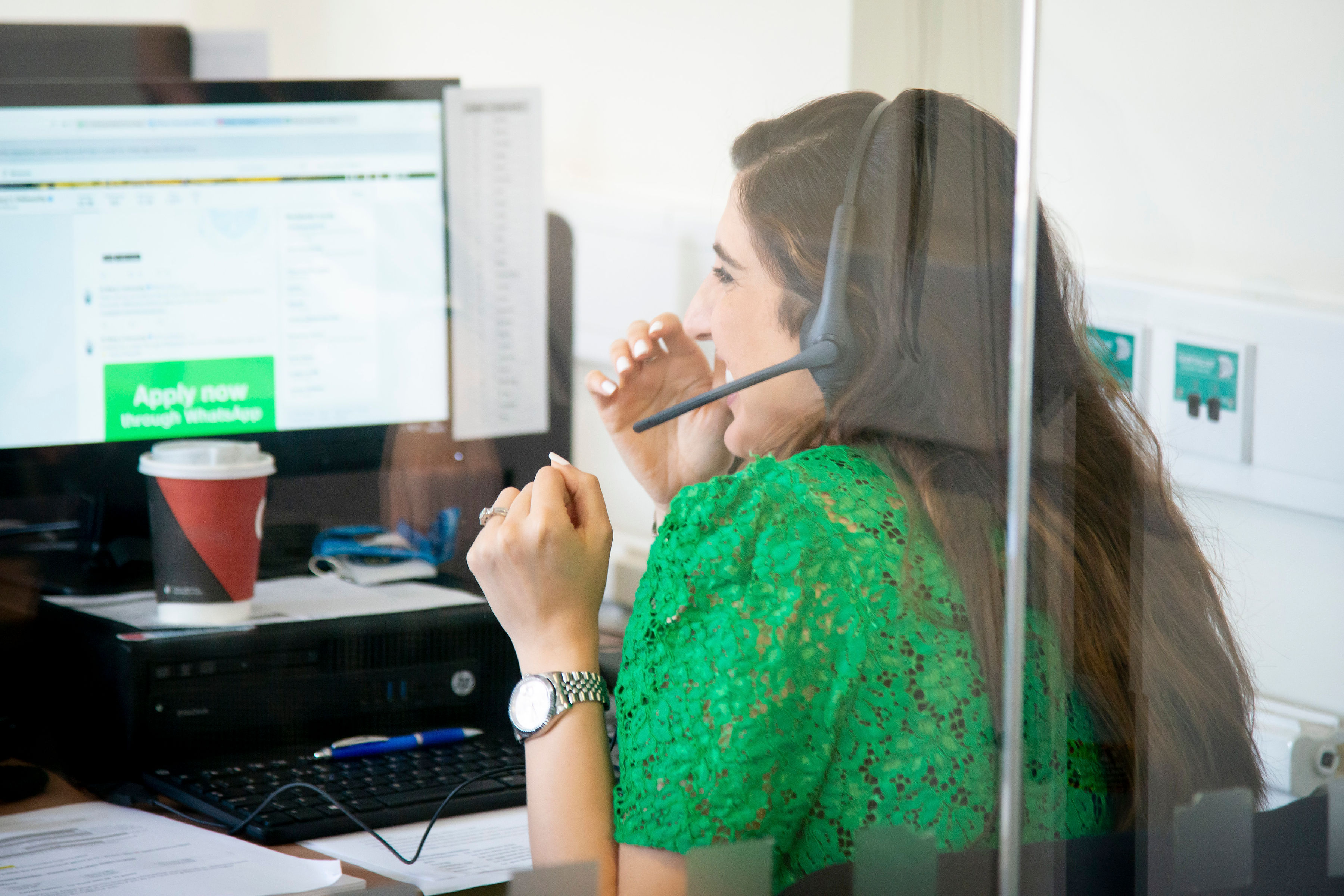 A member of the Clearing team laughs while on a call to a student